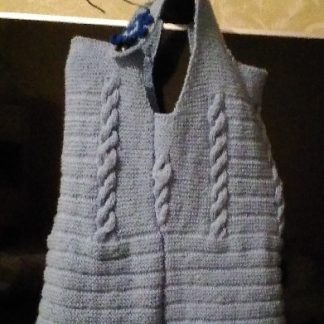 A photo of a handmade knitted pinafore dress for 2-3 years old girl. Side view. Merino wool 100%. (SKU 1-11)