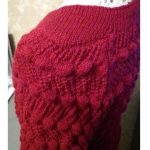 A photo of the knitted sweater. Color bordeaux, handmade. Sleeve's top view. Merino wool 100%. (SKU 1-9)